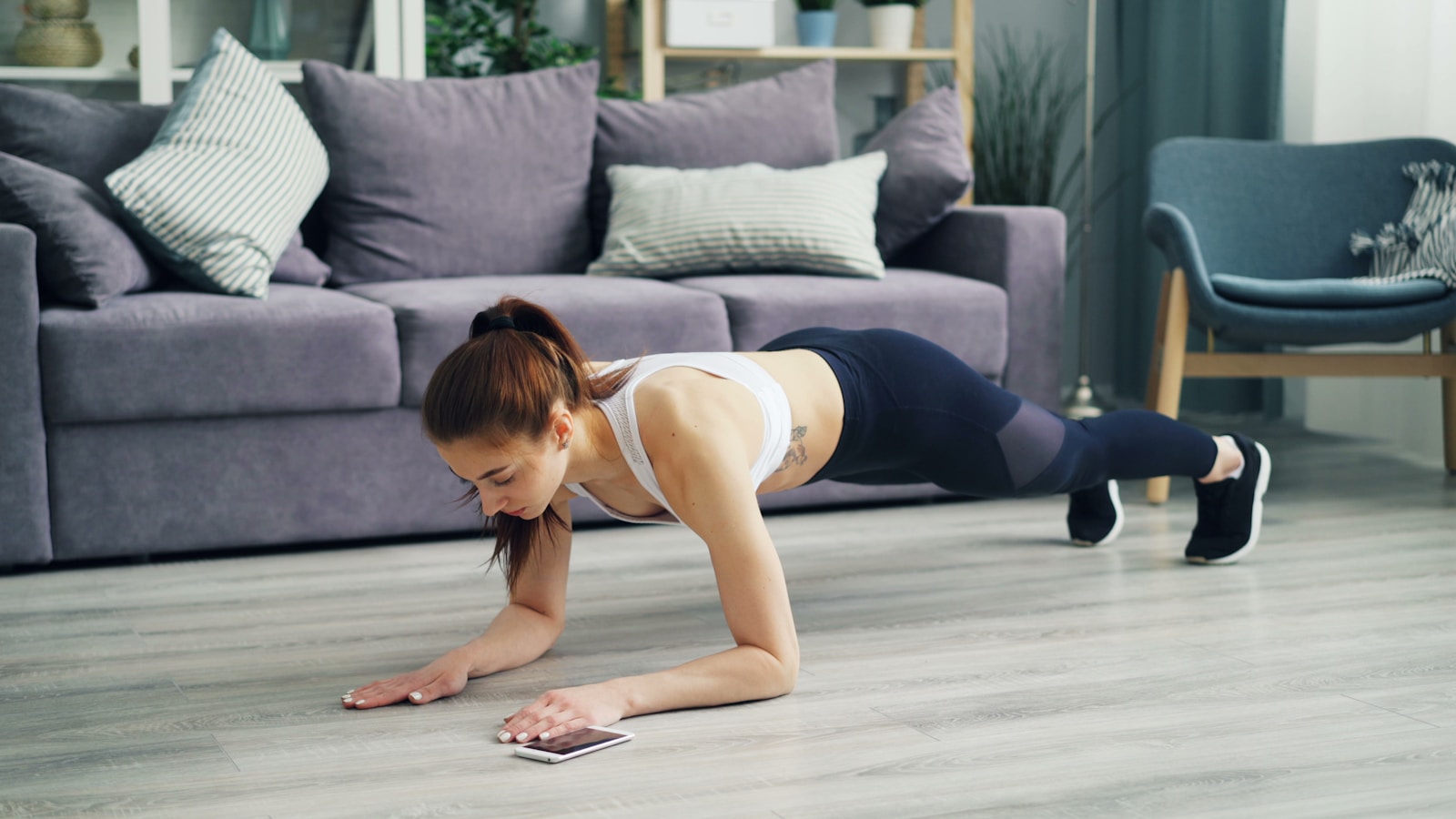 Frau in perfekter Plank Position beim effektiven Heimtraining für Frauen zu Hause